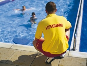 A lifeguard watches while swimmers play